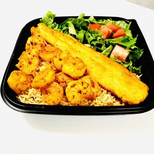 Grilled Shrimp and fish over rice and salad.