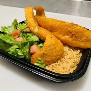 Fish over rice and salad