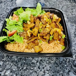 Grilled Lamb over rice and salad.