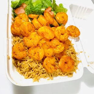 Grilled Shrimp over rice and salad.