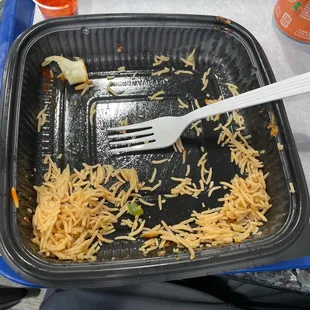 a plastic container with shredded cheese and onions