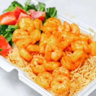 Grilled shrimp over rice and salad