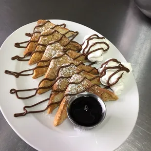 French Toast with Vanilla, Cinnamon, Nutella and just a little bit of whipped cream to start or end the day!!