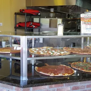 Lots of pies in the display cases, which are then sold by the slice and re-heated in the electric pizza ovens