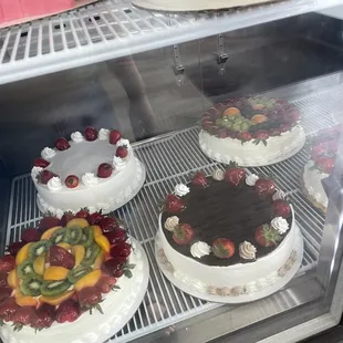 three cakes in a display case