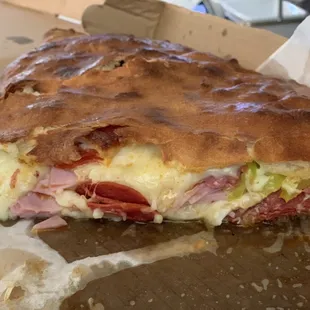 Half of the Large Italian Stromboli with salami and banana peppers.