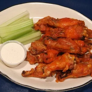 a plate of wings and celery