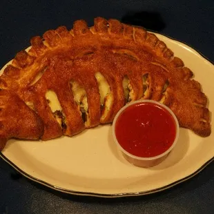 a croissant with a side of ketchup