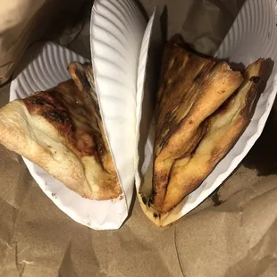 two slices folded between paper plates