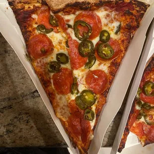 two slices of pepperoni and jalapeno pizza