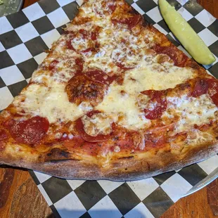 Pepperoni pizza and a pickle