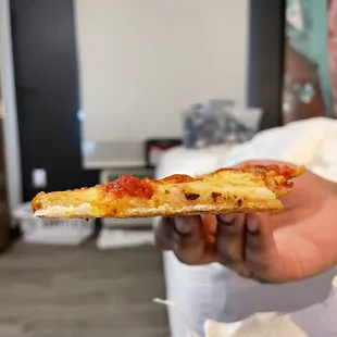 Paper thin pizza. It's thin slice pizza but gat damn