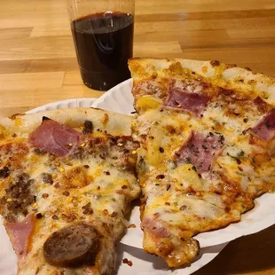 two slices of pizza on a paper plate