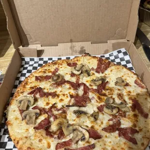 Bacon pizza with a white sauce, we added our own mushroom.