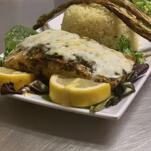 Herb Salmon on a bed of Pilaf Rice seasoned to perfection with grilled broccoli that&apos;s out of this world.