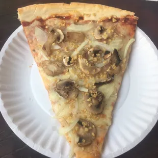 Pizza slice with mushrooms, onions, and look at that garlic!!!