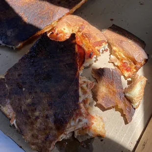 Burnt pepperoni and cheese pizza