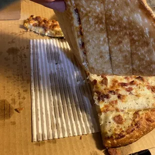 a slice being taken out of a pizza box
