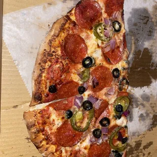 NY style pizza with pepperoni, jalapeños, olives n onions...