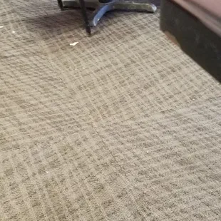 2 bandages laying on floor. Carpet is not clean.