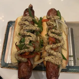 two hotdogs with toppings