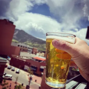 a person holding a glass of beer