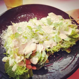a plate of salad and a glass of beer