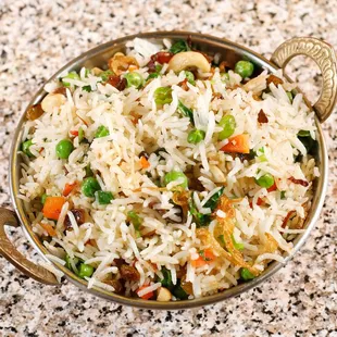 PULAW RICE: Rice sautéed with brown butter, Cashew, resins, peas, carrots and herbs.