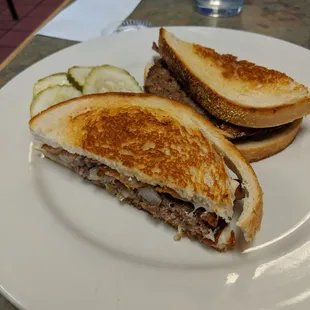 a sandwich and pickle on a plate