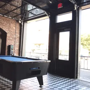 Glass garage doors that open onto the Highland strip.