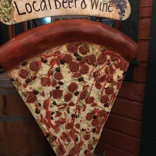 5 foot tall slice stands by the door.