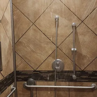 a shower in a tiled bathroom