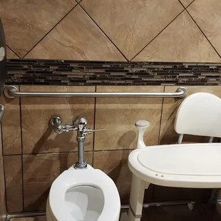 a toilet and a bathtub in a tiled bathroom