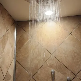 a shower head in a tiled bathroom