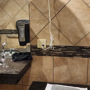 a sink and a fan in a bathroom