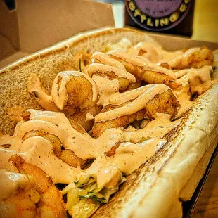 a hot dog with shrimp and gravy sauce