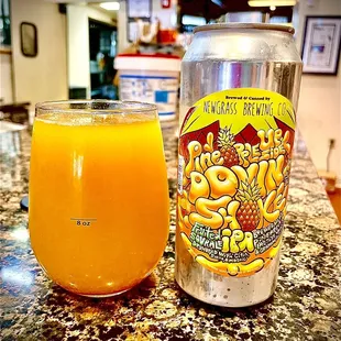 a can and a glass of orange juice