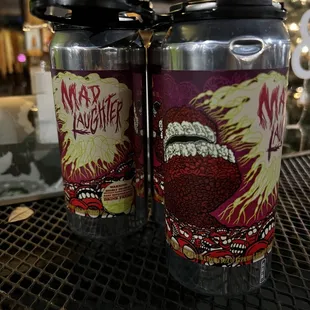 two cans of beer on a table