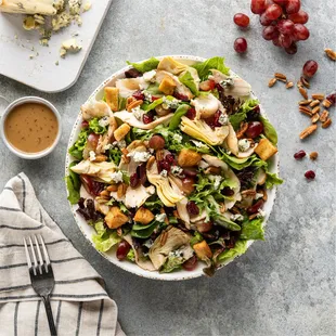 a salad with chicken, grapes, and cheese