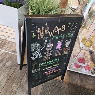 a chalkboard sign for the newora coffeehouse