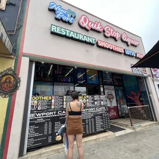 a woman standing in front of a restaurant