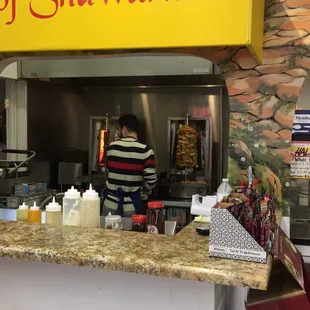 The Shawarma Master at work. Beef and chicken. Get the big wrap with Tahini sauce.