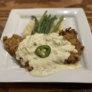 Chicken fried New York strip with jalapeño cream gravy