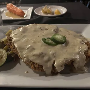of show - Country fried sirloin steak w/ jalapeño white country gravy on Chipotle &amp; garlic mashed potatoes. Sautéed fresh vegetable side.