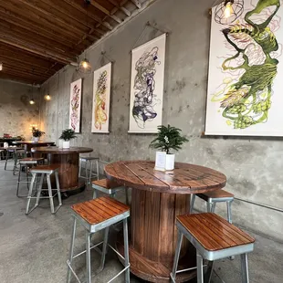 a dining area with tables and stools