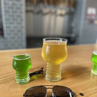 a pair of sunglasses and a glass of beer