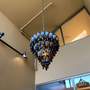 a chandelier made of beer bottles