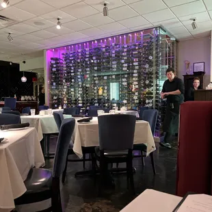 a view of a dining room with tables and chairs