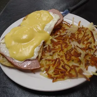 Eggs benedict with hash browns.