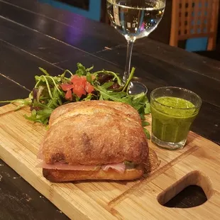 a sandwich and a glass of wine